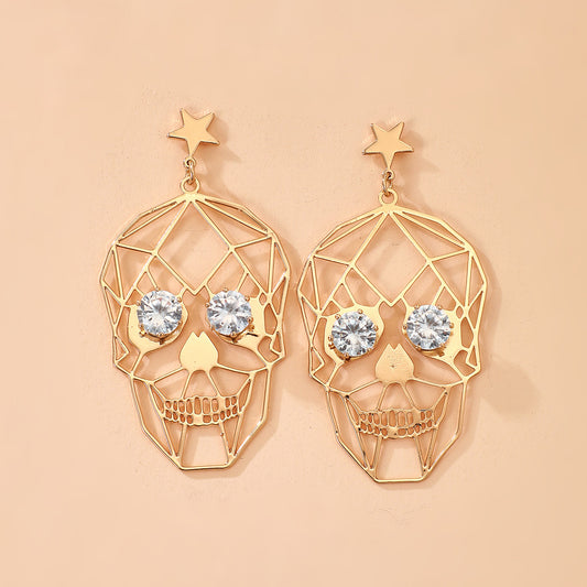 Boucles d'oreilles tête de mort yeux strass 